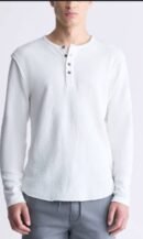 A man wearing a white, long-sleeve waffle-knit Henley shirt with a three-button placket, paired with light grey drawstring pants.