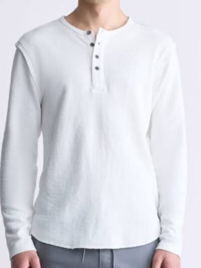 A man wearing a white, long-sleeve waffle-knit Henley shirt with a three-button placket, paired with light grey drawstring pants.