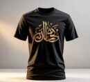 Men's black short-sleeve T-shirt featuring a highly visible metallic gold Arabic/Urdu calligraphy script print on the chest. Crew neck, regular fit. Keywords: Islamic, cultural, Eid, gold print, black tee.